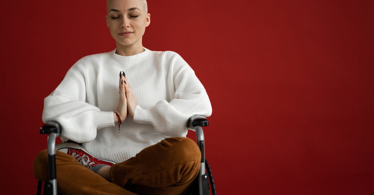 Lol disabled rewards [closed] - Young concentrated female with praying hands and crossed legs meditating during cancer recovery process on red background
