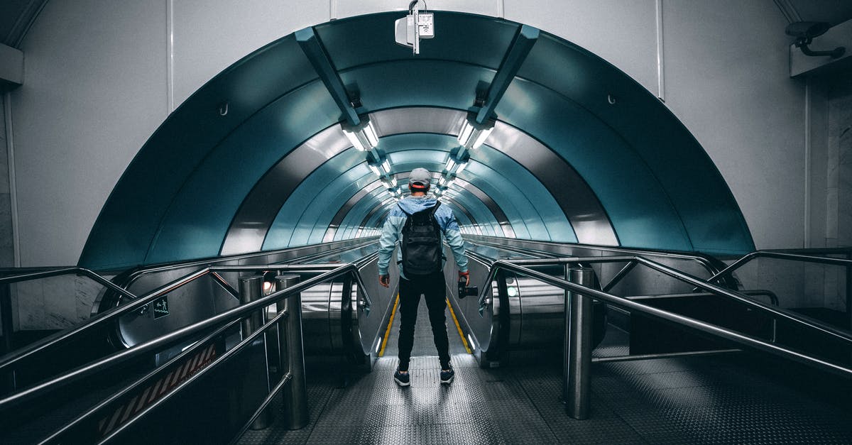 London Underground Simulator won't start - Back View of a Person Standing in Front of a Moving Walkway