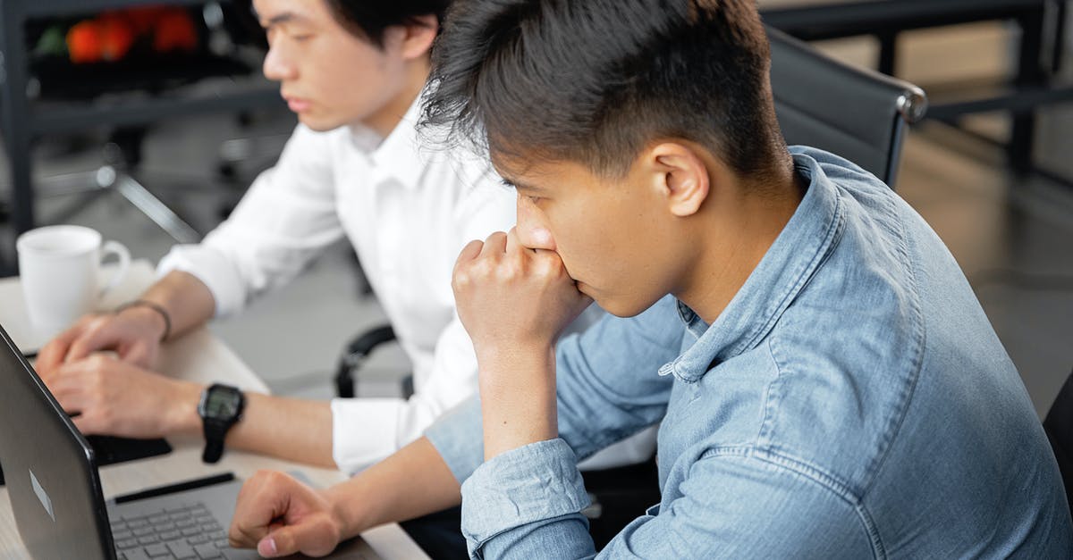 Longer commmand execution - A Person in Smart Casual Attire Using a Laptop beside a Coworker