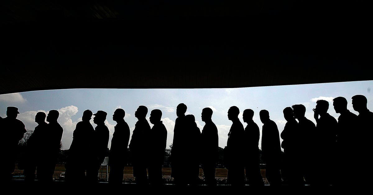 Lower Priority Queue - Group of Men Forming a Libe Lower Priority Queue - Group of Men Forming a Libe