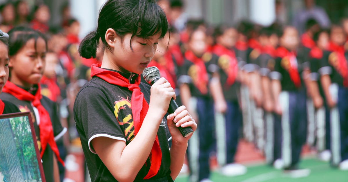 Lower Priority Queue - Woman Wearing Red Handkerchief on Neck Holding Black Microphone Lower Priority Queue - Woman Wearing Red Handkerchief on Neck Holding Black Microphone