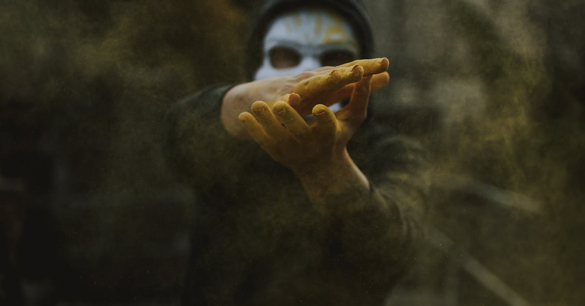 Mad Scientist Interaction with duplicate secrets - Man in mask clapping hands and spreading powder Mad Scientist Interaction with duplicate secrets - Man in mask clapping hands and spreading powder