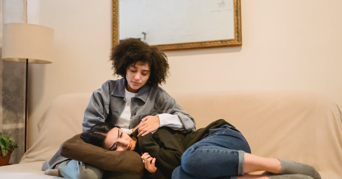 Madden 16 problem on XB1 - resetting every time - Young black woman supporting crying female friend on couch Madden 16 problem on XB1 - resetting every time - Young black woman supporting crying female friend on couch