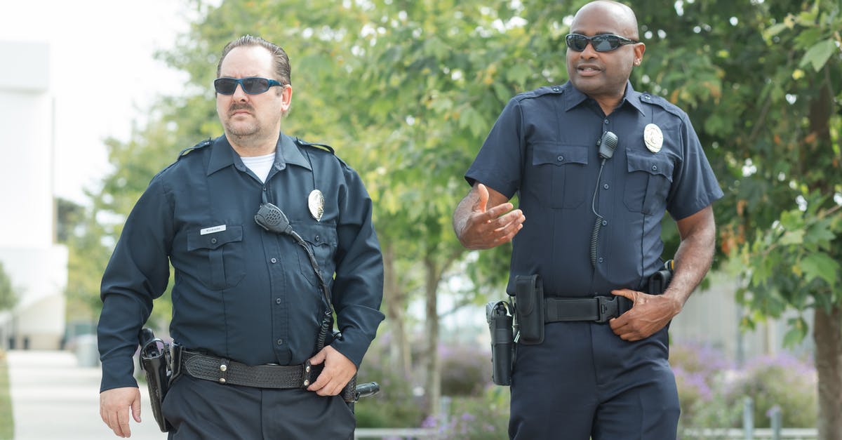 Make Guns Available? - Policemen Walking on the Street Make Guns Available? - Policemen Walking on the Street