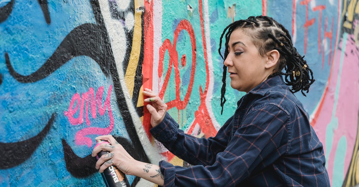 Making mobs invincible - Woman in Blue and Black Plaid Jacket Holding Black Bottle