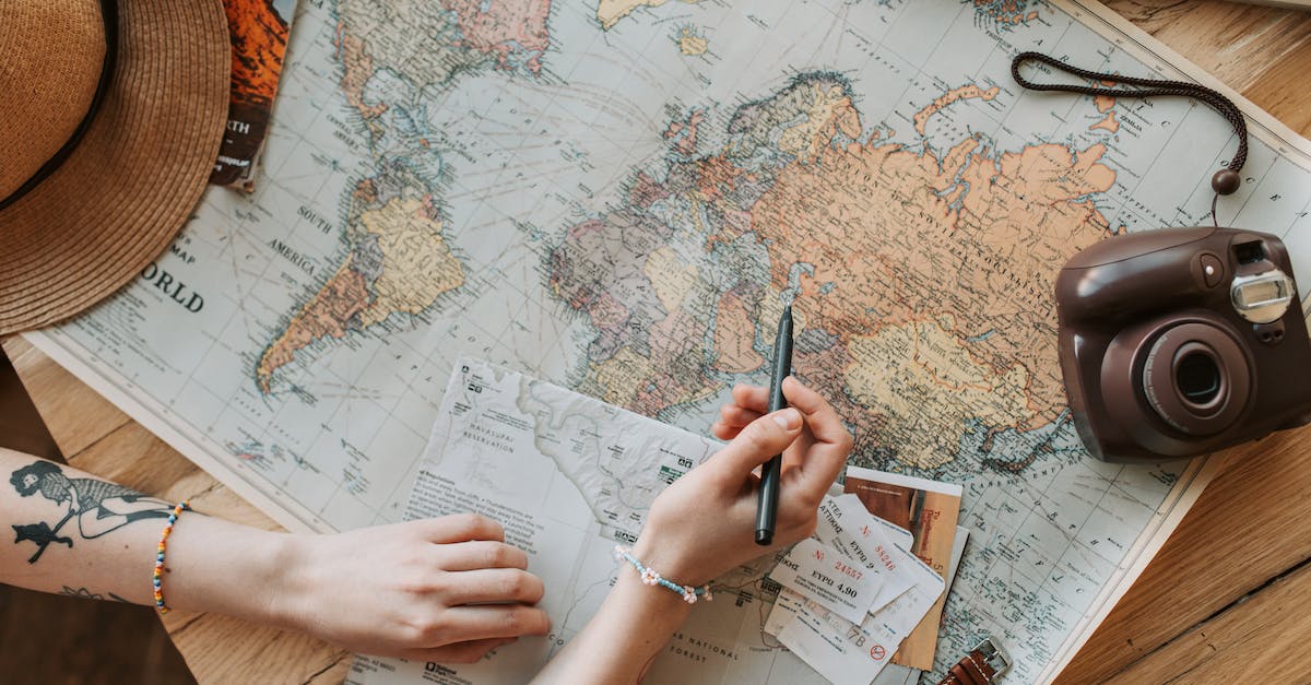 Map challenges is bronze and higher? - Woman Looking at a Map with a Pen in Her Hand 