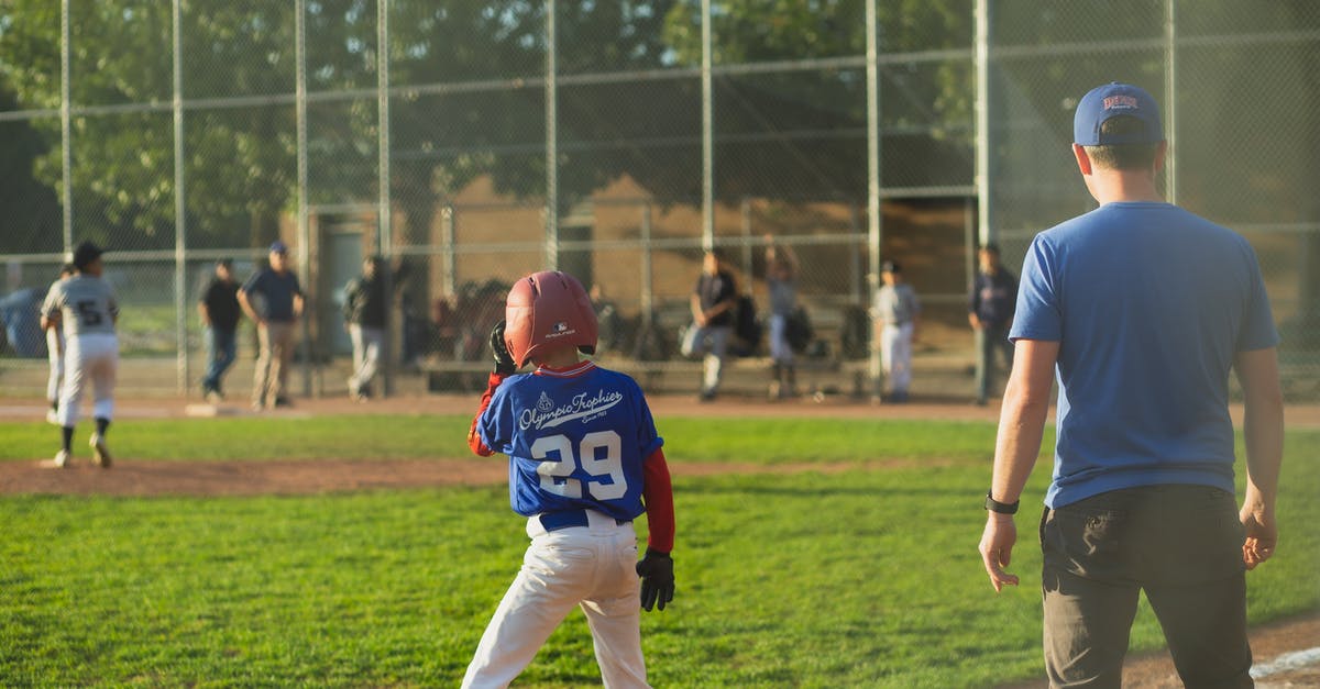 Maximum number of survivors in team - Unrecognizable trainer with sportsmen in baseball field Maximum number of survivors in team - Unrecognizable trainer with sportsmen in baseball field