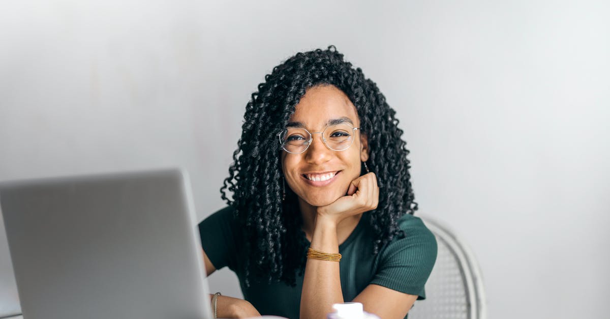 Meaning of fourth option when selecting furniture in room? - Happy ethnic woman sitting at table with laptop