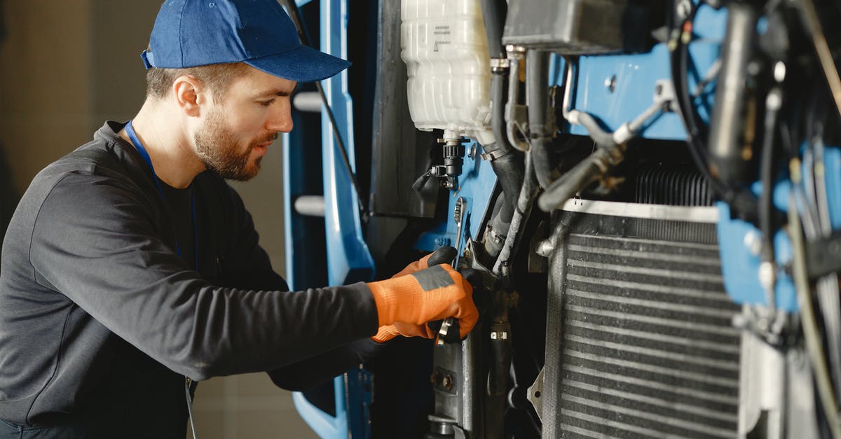 Melding commands with mastered abilities - Man in Black Long Sleeve Shirt Repairing Blue Machine Melding commands with mastered abilities - Man in Black Long Sleeve Shirt Repairing Blue Machine