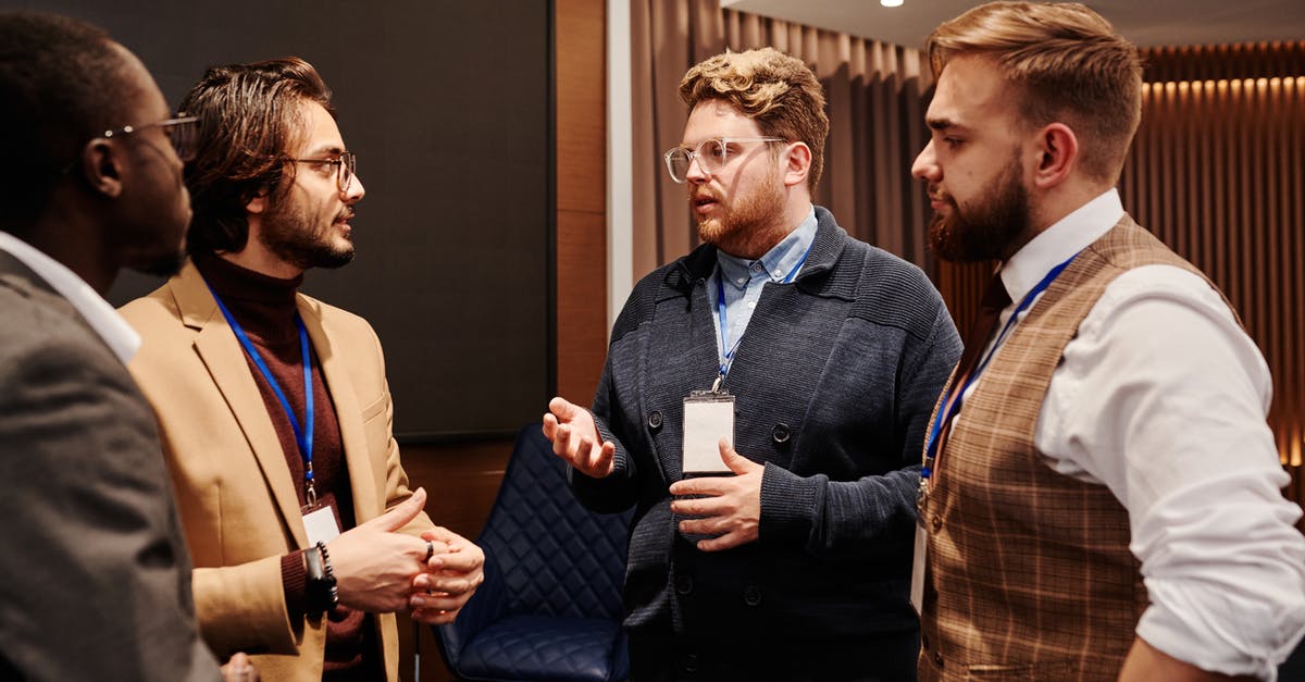 Mic not working? - Men in Discussion at an Event Mic not working? - Men in Discussion at an Event