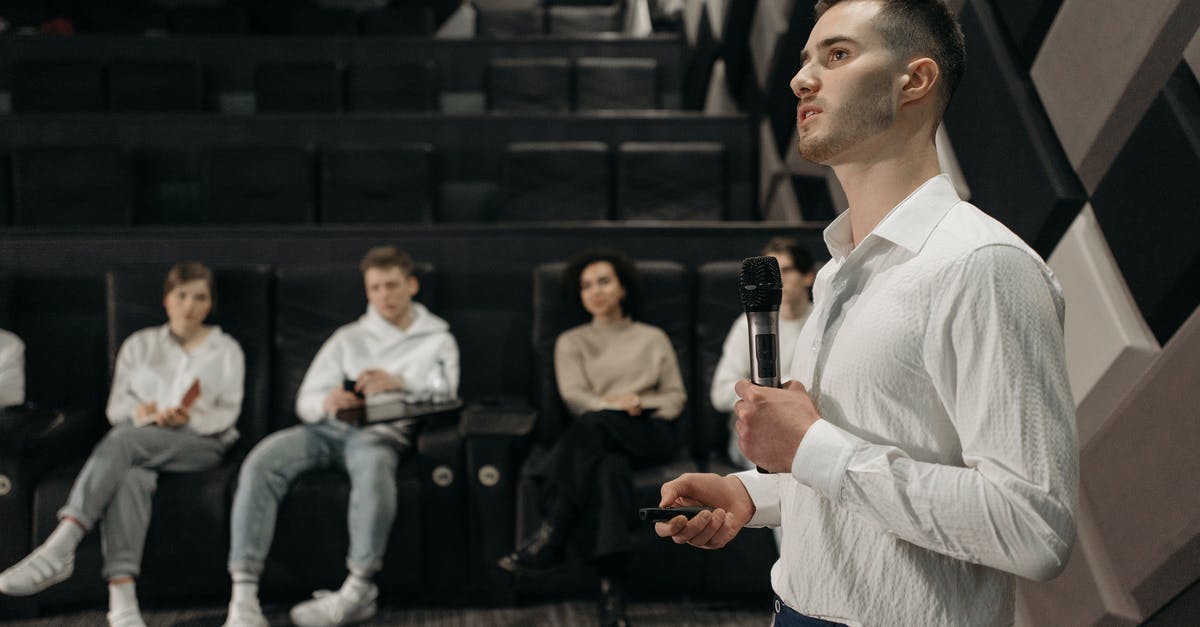 Microphone not working for team but works for group - Man in White Dress Shirt Holding Microphone Doing a Presentation