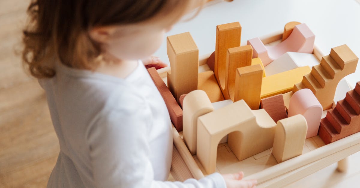 Minecraft 1.10.2 command block doesn't activate other command block - Unrecognizable little girl playing with wooden blocks at table at home