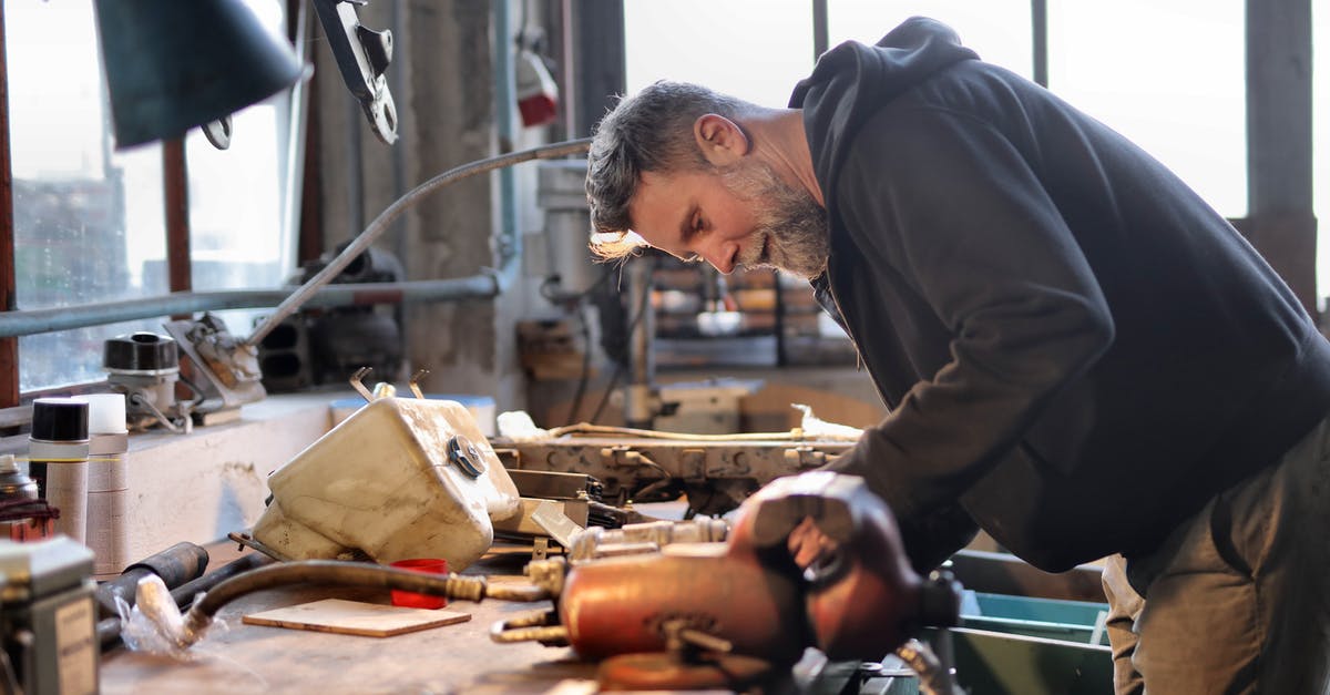 MINECRAFT : Failed to login : The authentication are currently down for maintenance [duplicate] - Side view of brutal male worker in casual wear standing at workbench and fixing metal details while using tools and working in workshop