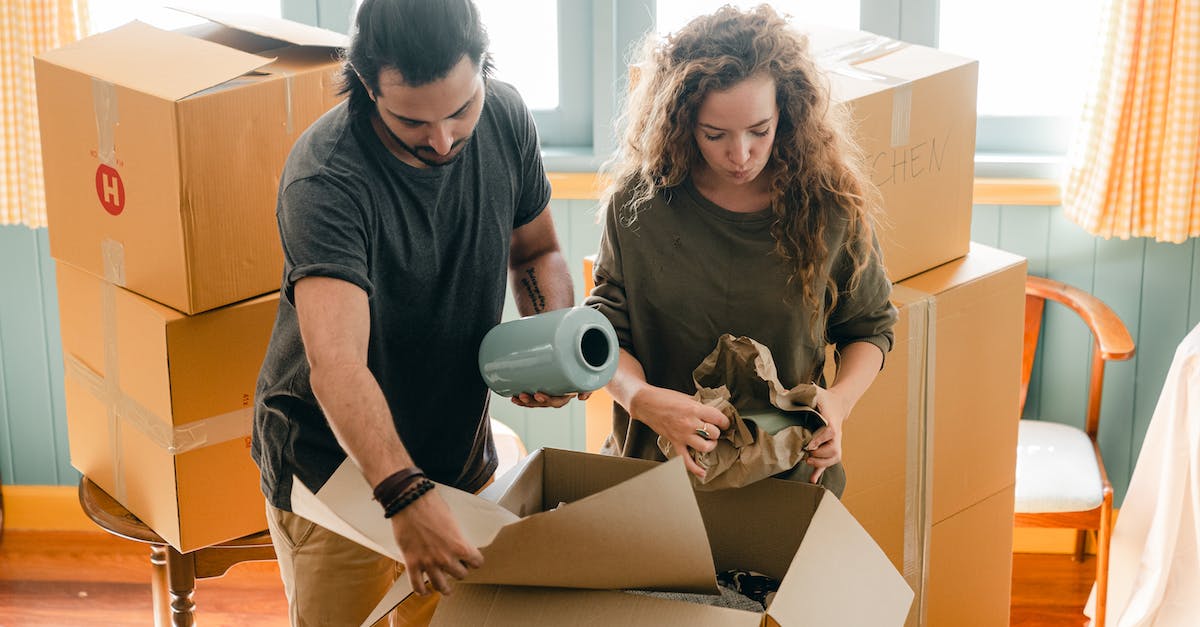 Minecraft alpha 1.2.6 lags when loading new chunks. Anyway to tone down the lag? - Multiethnic couple packing belongings in parchment near pile of boxes