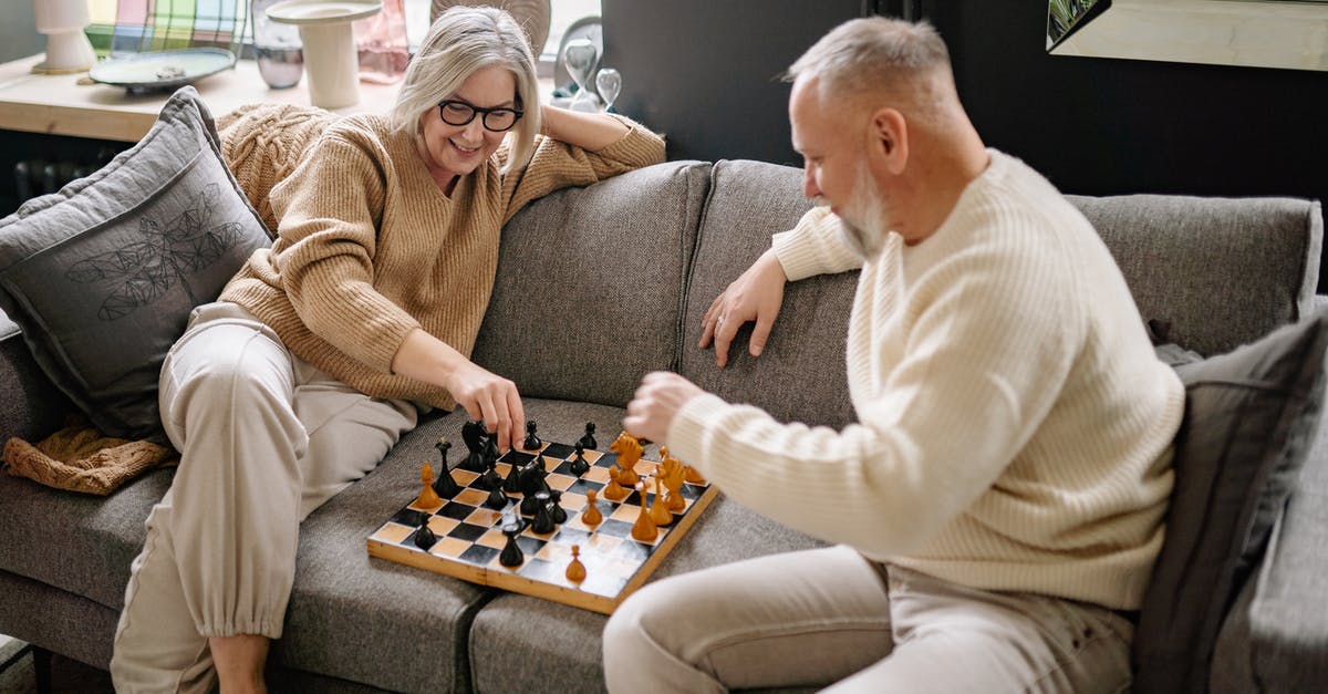 Minecraft Better Together Servers on Xbox One - Couple Sitting on a Couch While Playing Chess Minecraft Better Together Servers on Xbox One - Couple Sitting on a Couch While Playing Chess