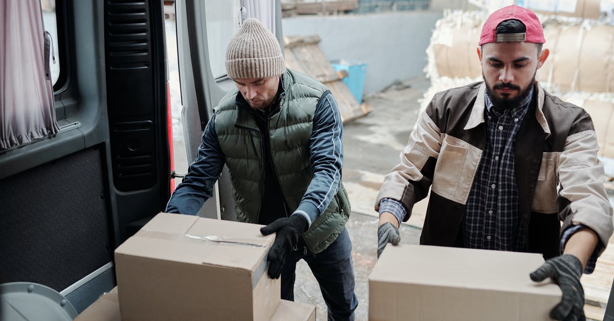 Minecraft chunks not loading - Man in Black and Gray Jacket Holding Brown Cardboard Box