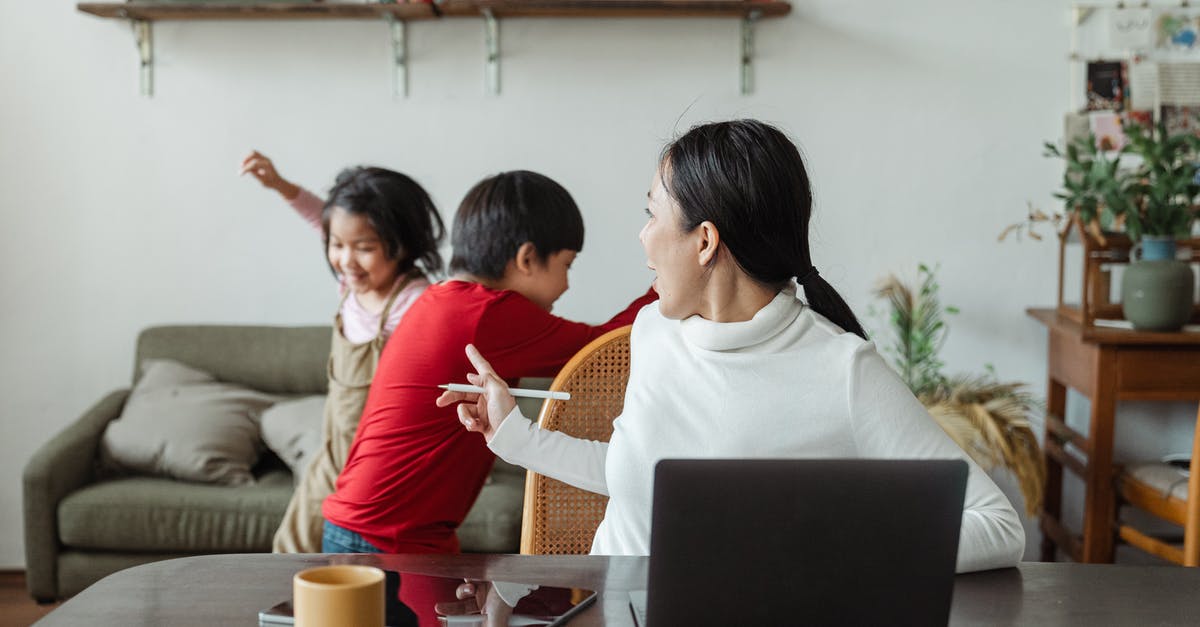 Minecraft Dungeons local co-op is broken with Remote Play - Young Asian working mother scolding little kids playing and making noise during remote job at home