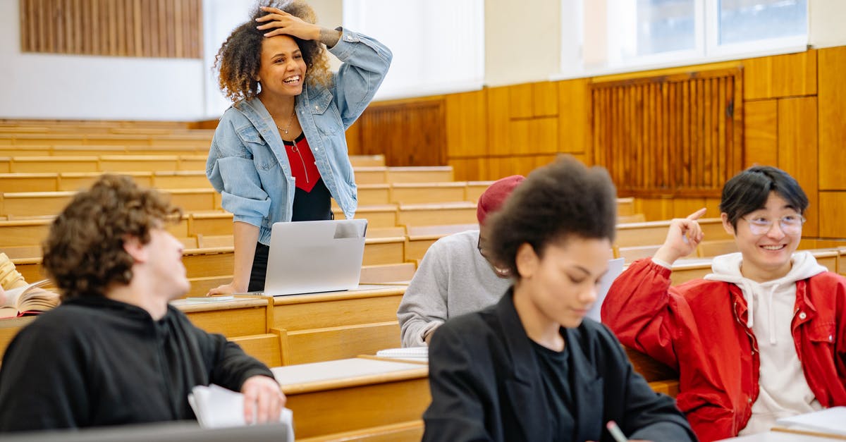 Minecraft Error: Could not find or load main class - Boy in Black Hoodie Sitting Beside Boy in Red Jacket
