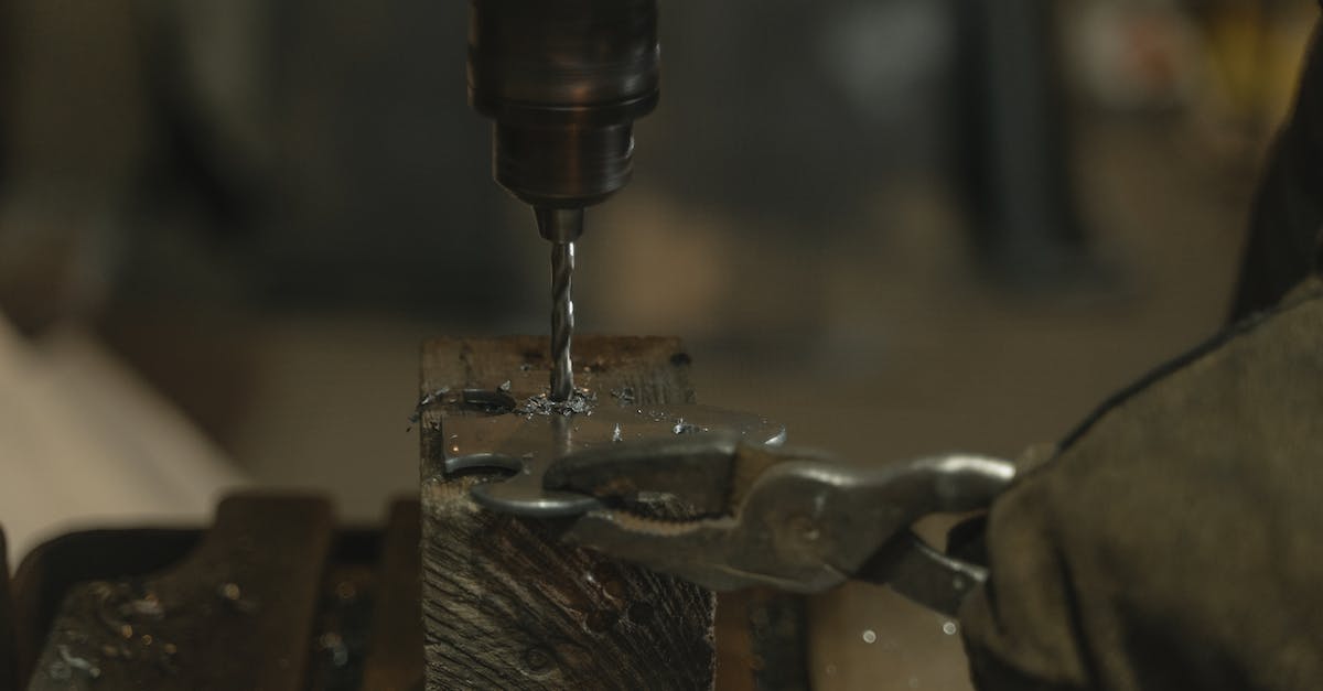 Minecraft forge 1.7.2 [closed] - Close-Up Shot of a Person Drilling a Metal