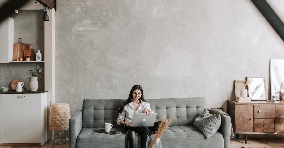Minecraft: Invalid Credentials - Cannot login on home network [duplicate] - Happy female remote worker in eyeglasses sitting on cozy sofa with netbook and cup of coffee in loft style room with wooden floor and concrete wall