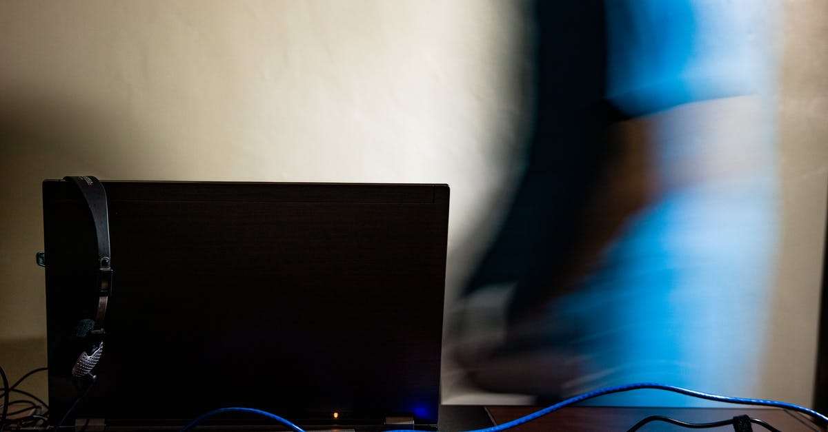 Minecraft LAN connecting to server for long time [duplicate] - Long exposure of anonymous male in blue t shirt walking toward black computer in light room