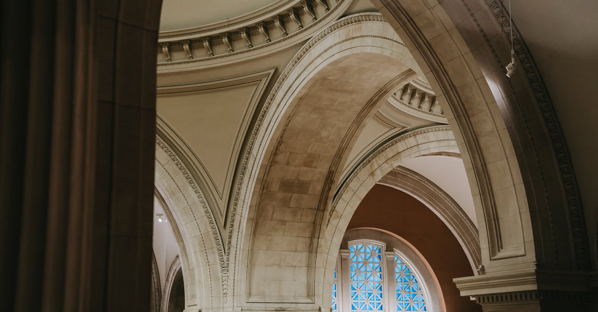 Minecraft lightning strike inside building - From below of museum hall with arched passages with ornamental decoration on ceiling and illuminated with lamps