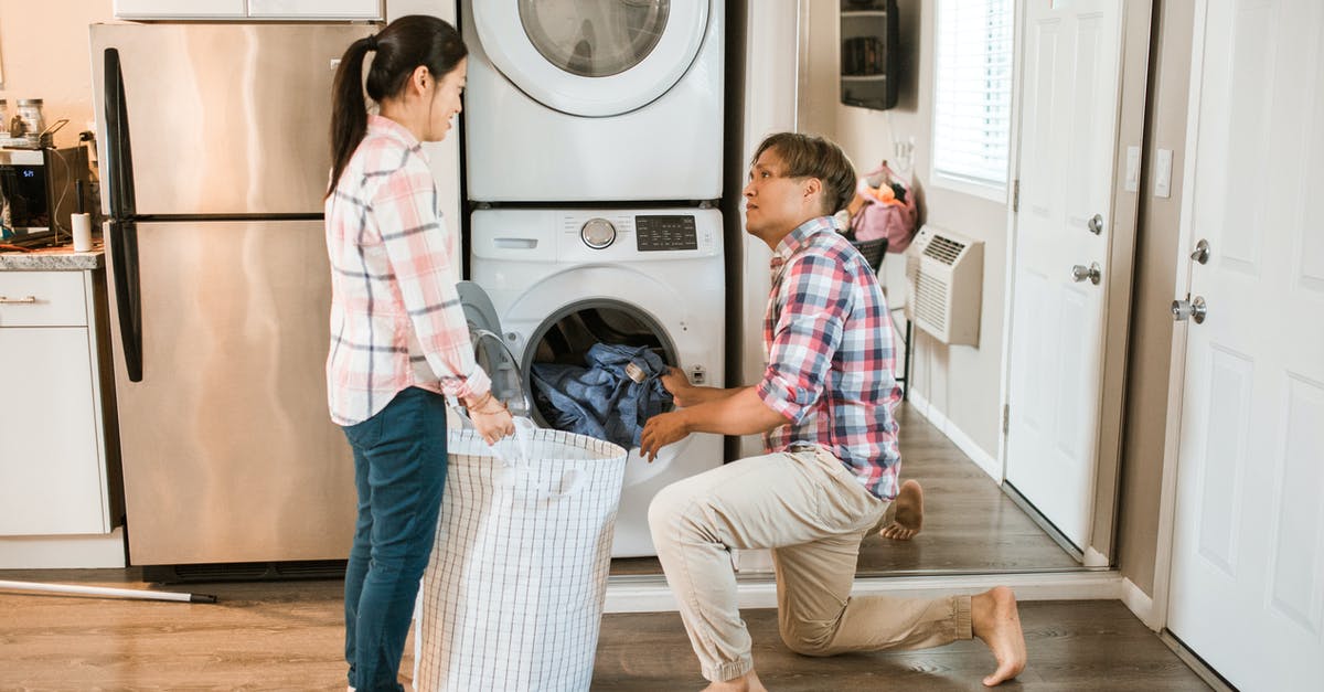 Minecraft loading problems? - Man Loading Clothes In A Washing Machine While Woman Is Holding A Laundry Basket Minecraft loading problems? - Man Loading Clothes In A Washing Machine While Woman Is Holding A Laundry Basket