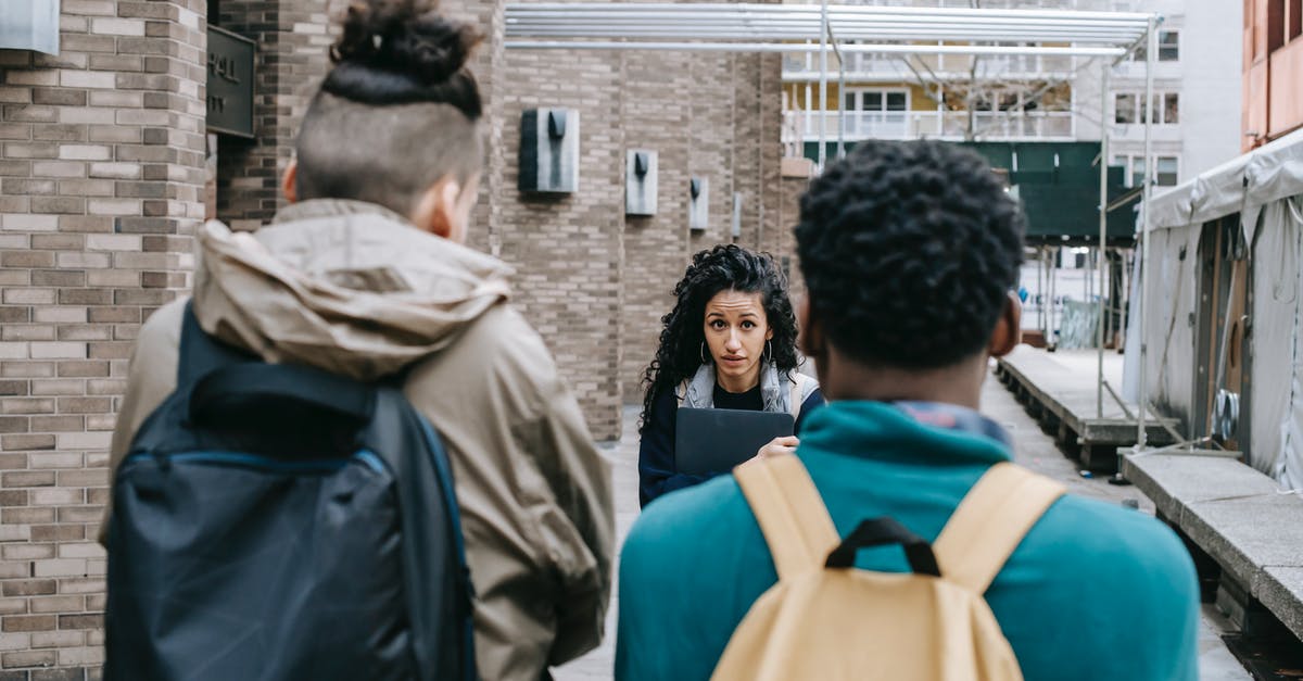 Minecraft mined block reappears and other problems [closed] - Back view of faceless multiracial friends with backpacks blocking way for Latin American classmate