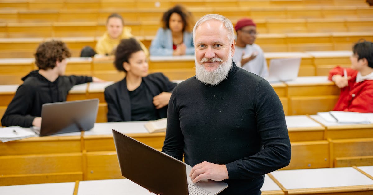 Minecraft offline - Professor in Black Turtleneck Sweater Holding Silver Macbook in Classroom