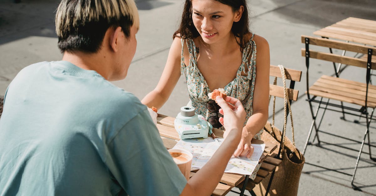 Minecraft PE Other area of the map is not loading - Smiling ethnic woman talking to unrecognizable boyfriend in street cafeteria