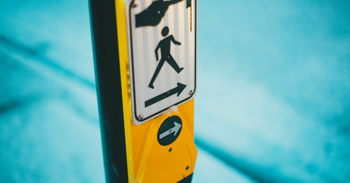 Minecraft: Prevent snow from accumulating around - Selective focus of blind and deaf friendly pedestrian crosswalk control button for changing traffic lights and crossing street on zebra in traffic with sign on street