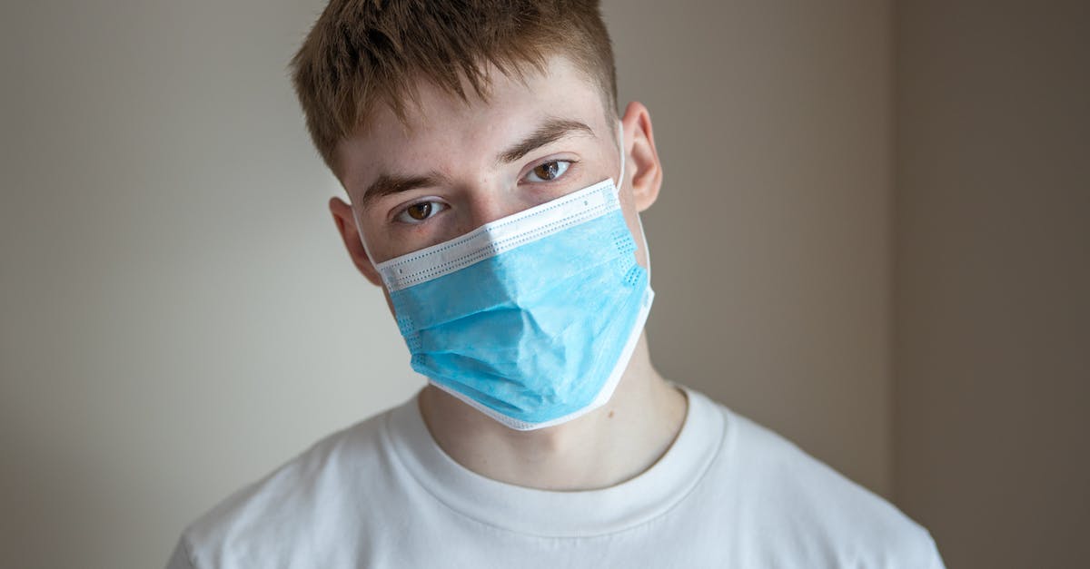 Minecraft Server Hide Plugins & Commands Help - Serious young male wearing casual shirt and respirator standing against gray wall and looking at camera
