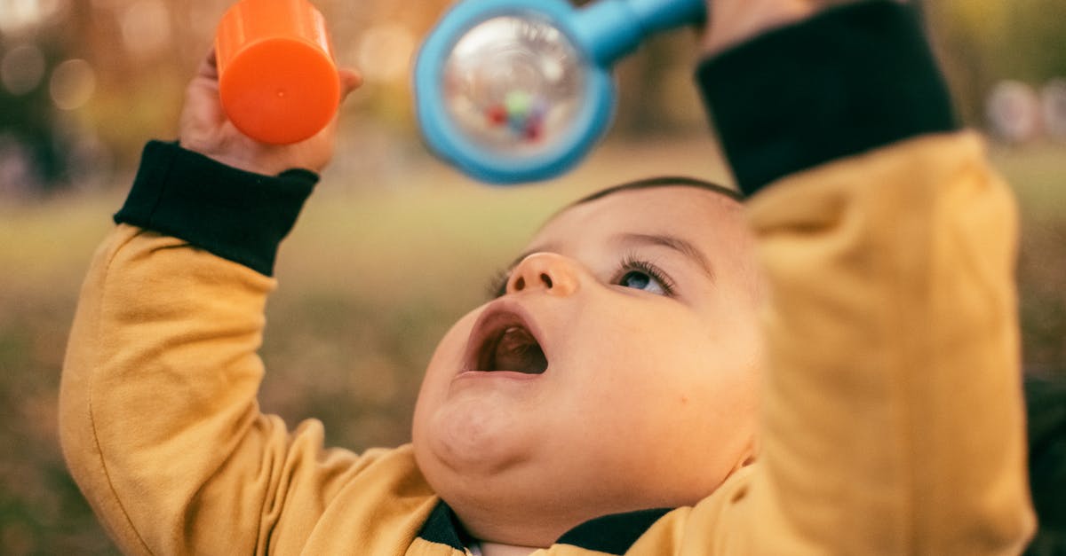 Minecraft stops playing [closed] - Child in Yellow Long Sleeve Shirt Holding Blue Red and Yellow Balloons