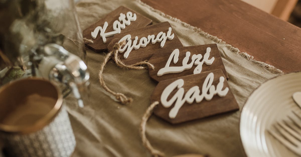 Missing name tags! - Wooden name tags arranged on table during wedding ceremony