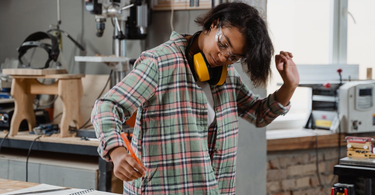 Missing options in carpenter's workbench - A Woman Looking at the Notebook on the Wooden Table Missing options in carpenter's workbench - A Woman Looking at the Notebook on the Wooden Table