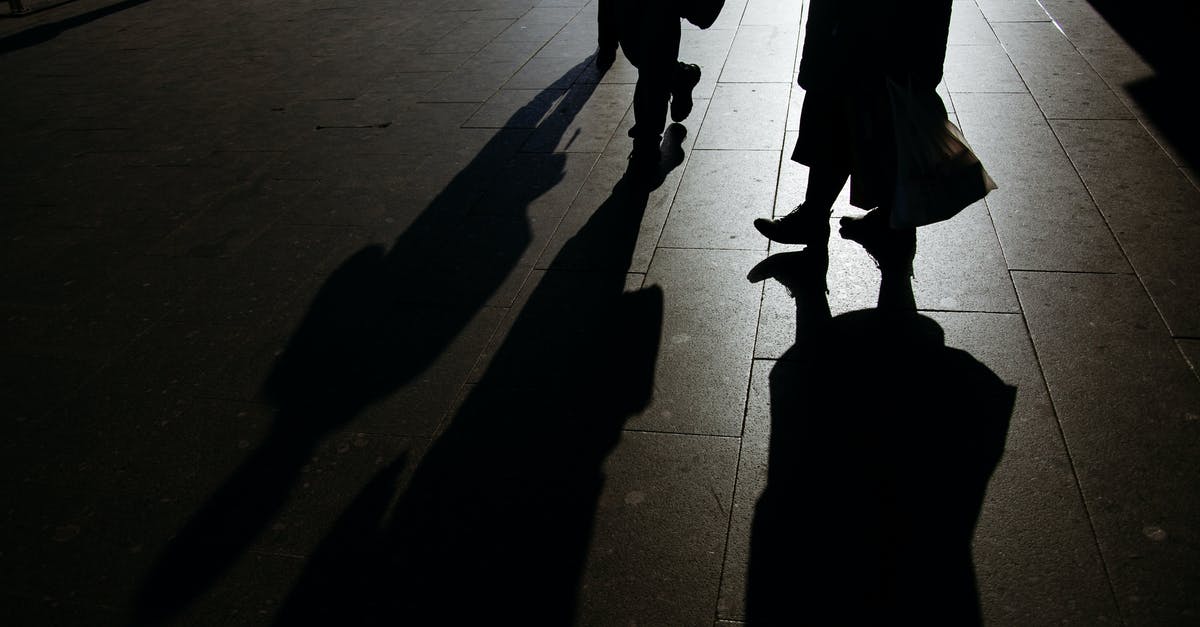 Mob spawning platform isn't dark even without torches - Anonymous pedestrians strolling on paved sidewalk at night