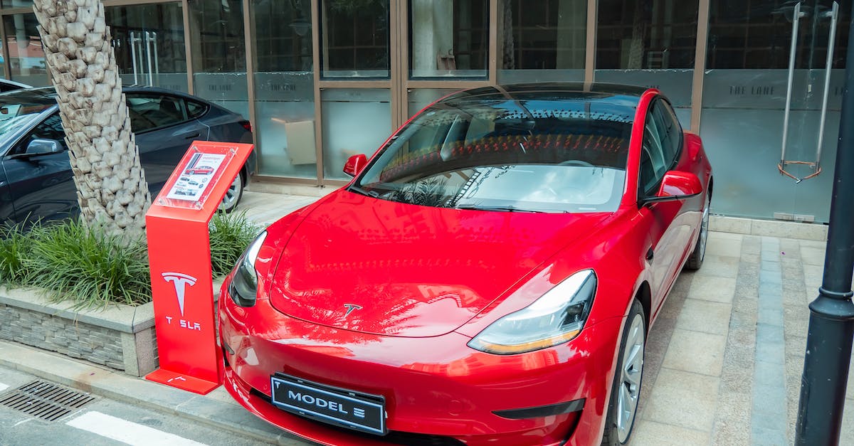 Mobs named jeb_ - Red Tesla Car Parked Outside a Building