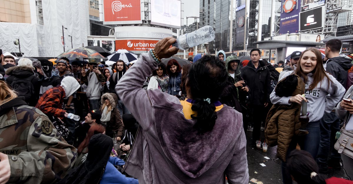 More efficient way to gather ripened mushrooms? - Group of people in warm clothes standing on crowded street amidst contemporary buildings in city during mass festival in daytime