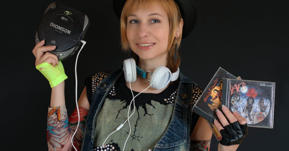 Mortal Kombat Komplete Edition for PS3 includes DLC on disc or as a voucher code? - Smiling Woman Holding a Walkman and Compact Disc Mortal Kombat Komplete Edition for PS3 includes DLC on disc or as a voucher code? - Smiling Woman Holding a Walkman and Compact Disc