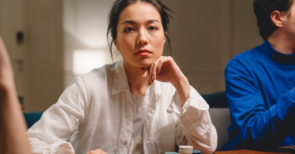 Most effective money making strategies - Focused young lady with unrecognizable friends playing board game with tokens in casino Most effective money making strategies - Focused young lady with unrecognizable friends playing board game with tokens in casino