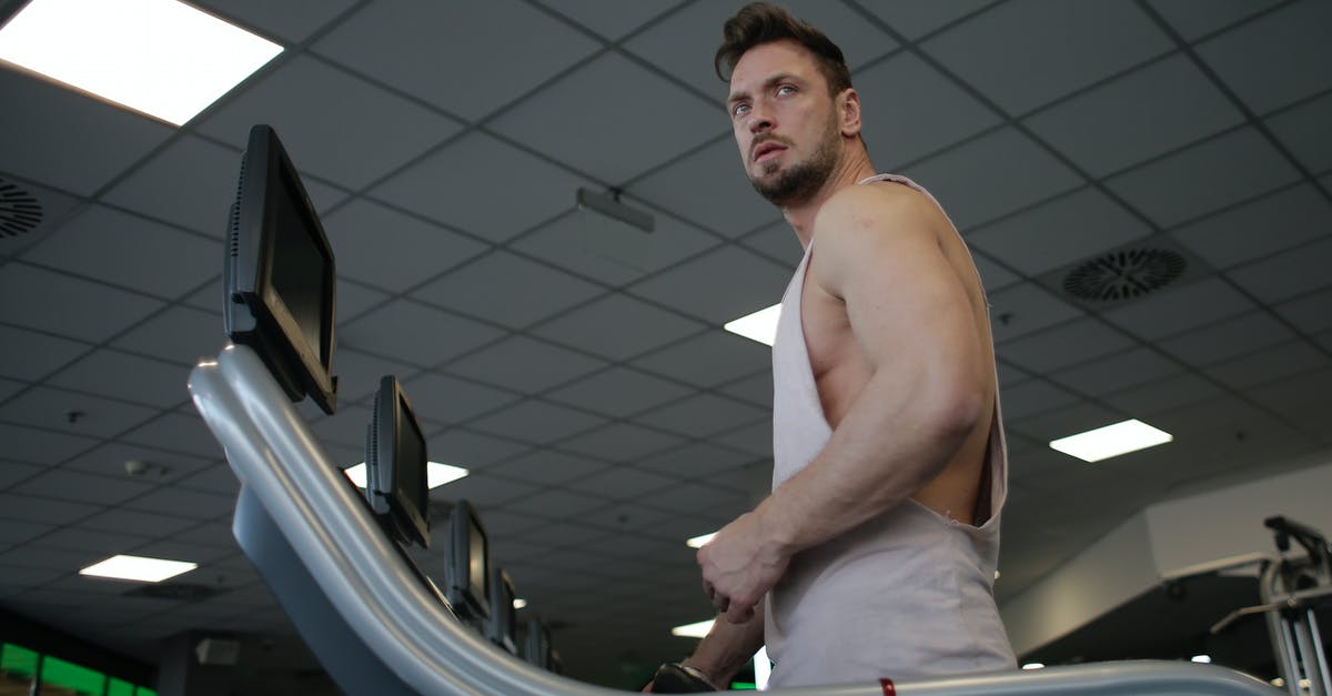 Most effective use of coupons and ingots for increasing power - Strong sportsman using treadmill for cardio workout in gym