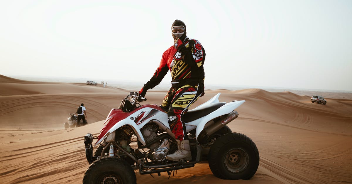 Motor skill: Let speed come naturally? - Man in helmet on quad bike in desert Motor skill: Let speed come naturally? - Man in helmet on quad bike in desert