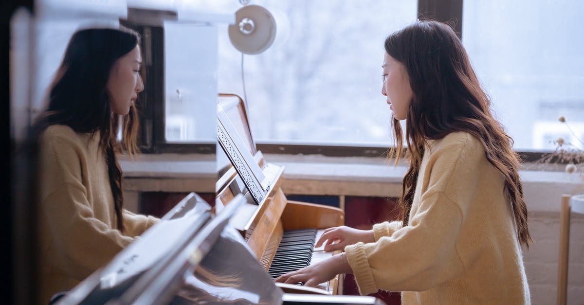 Movement and sound issues and freezing in Jedi Outcast and Academy - Side view of young ethnic female pianist playing piano while watching music score during rehearsal Movement and sound issues and freezing in Jedi Outcast and Academy - Side view of young ethnic female pianist playing piano while watching music score during rehearsal