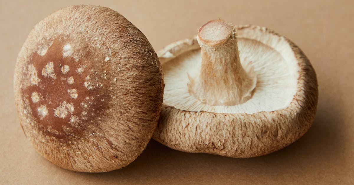 Mud cannot be planted with Glowing Mushroom Seeds? [duplicate] - High angle of delicious raw mushrooms with spotted caps placed on light brown background