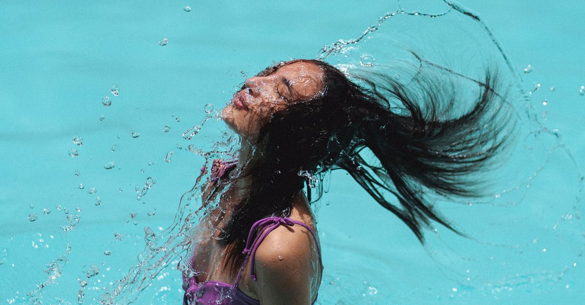 Muffalo with blue wrap cover around it? - Slim waving hair in blue water of resort pool Muffalo with blue wrap cover around it? - Slim waving hair in blue water of resort pool