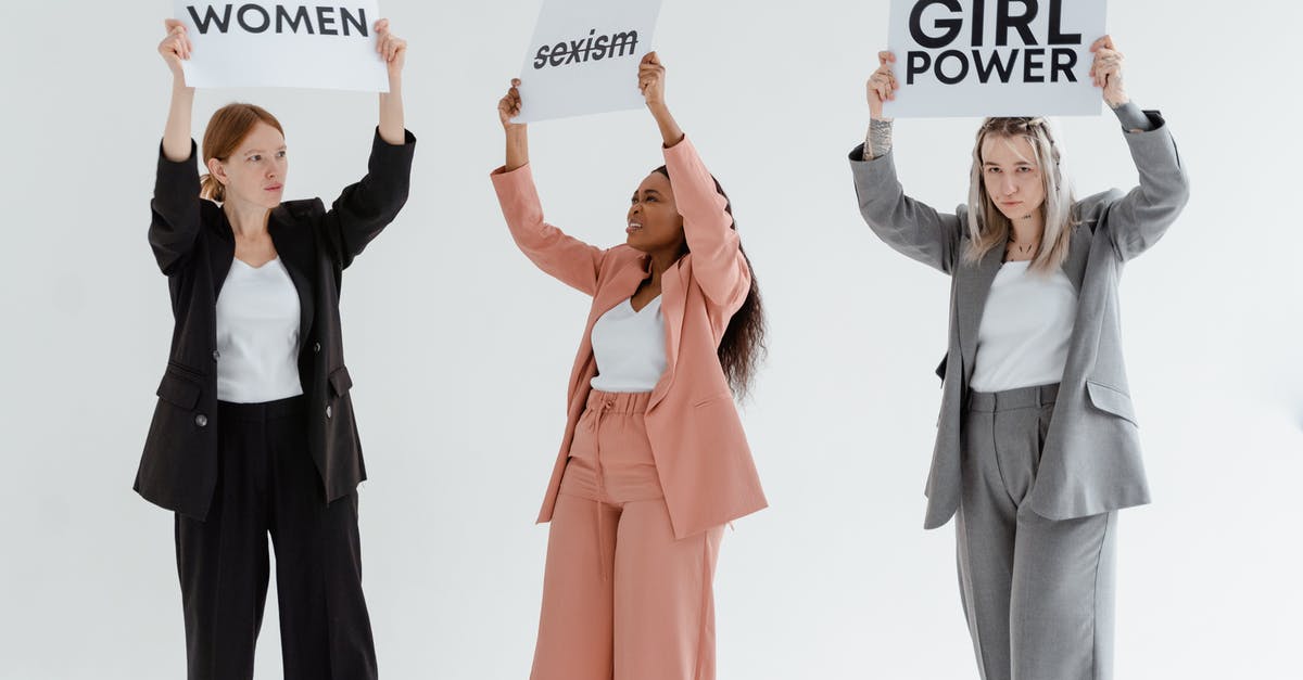 Multiple subfaction leaders - Women in Blazer and Pants Raising Placards