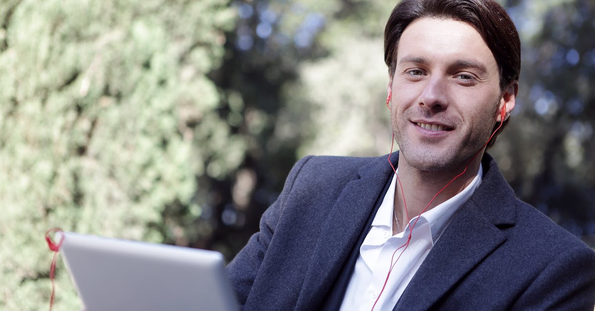 Music sounds all choppy - Man Holding a Silver Tablet Listening to Music Music sounds all choppy - Man Holding a Silver Tablet Listening to Music