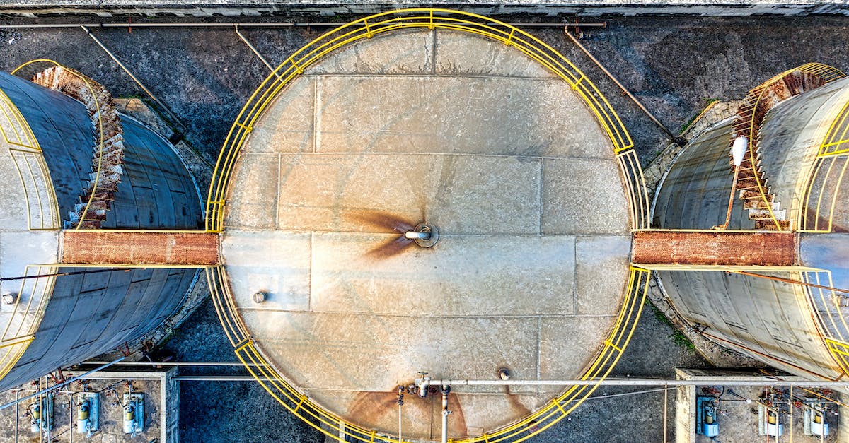 My cocaine refinery can't produce output because my storage is always full of weed. What should I do? - Top view of huge industrial tanks connected with rusty passages located at territory of factory