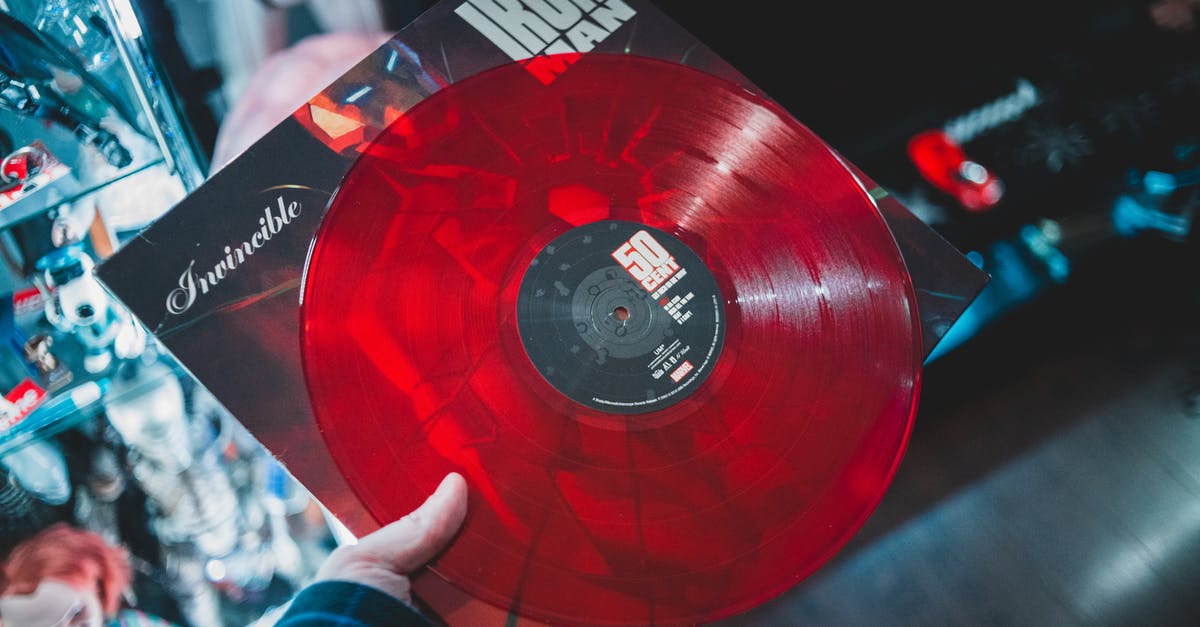 My Google Play Store is glitching so I can't download Minecraft - From above crop person holding red vinyl disc with inscription cover in music shop