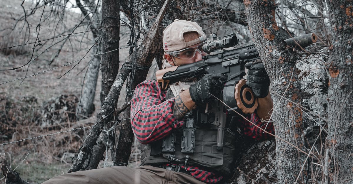 My helmet durability is 0? - Man in Red and White Checkered Dress Shirt Holding Black Assault Rifle